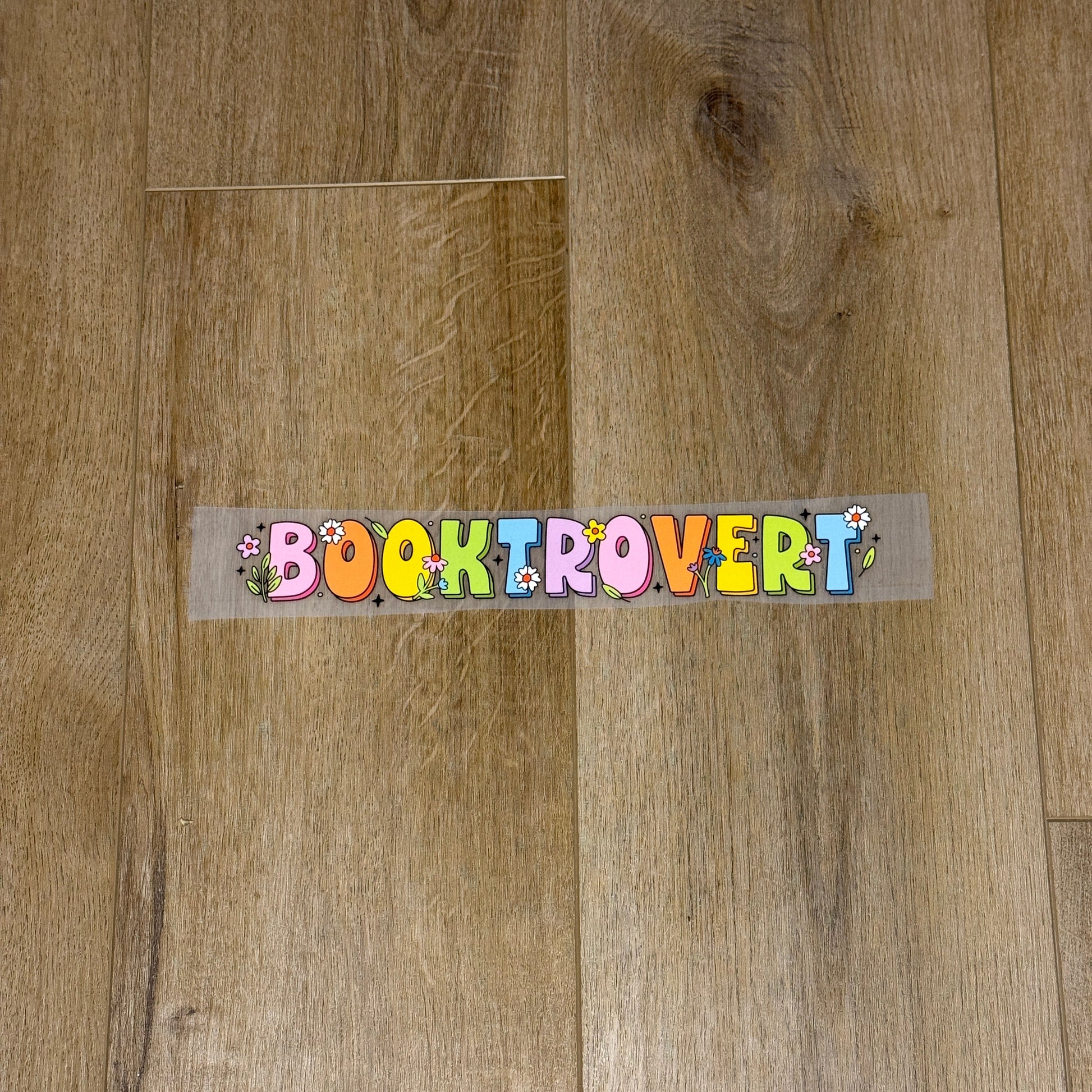 Colorful Booktrovert screen print transfer for finished apparel. Book lovers