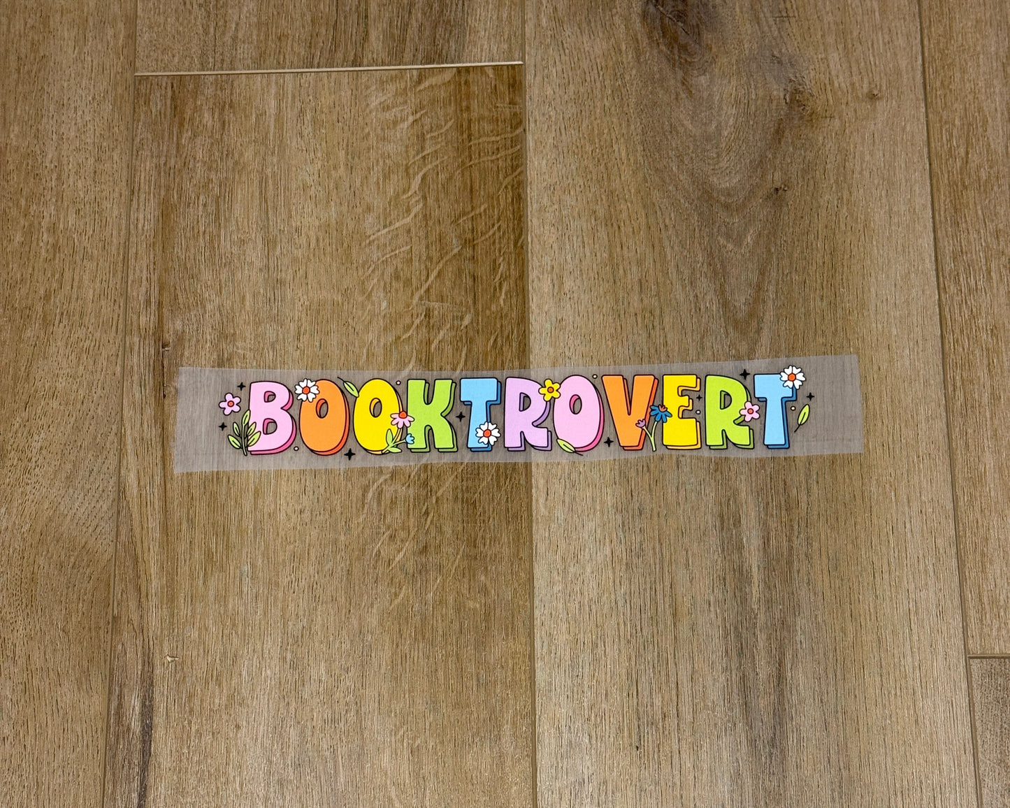 Colorful Booktrovert screen print transfer for finished apparel. Book lovers